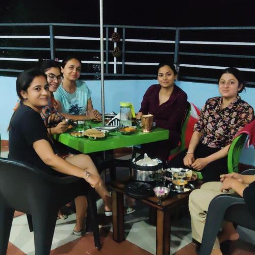 a group of people sitting around a table at Rock Mountain Premium Stay Near Rock Garden Dalhousie in Dalhousie