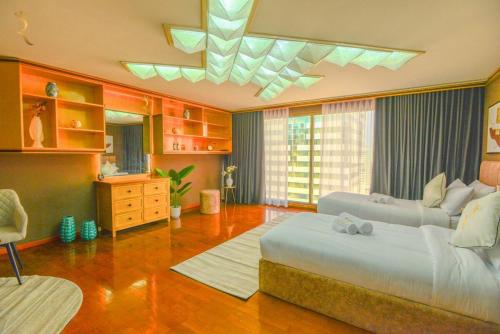 a large bedroom with a large bed and a desk at Timeless Elegance - Italian-Style Penthouse Retreat Near Corniche & WTC Mall in Abu Dhabi