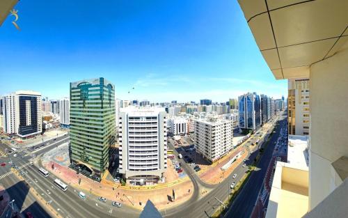 a view of a city with buildings and a highway at Timeless Elegance - Italian-Style Penthouse Retreat Near Corniche & WTC Mall in Abu Dhabi