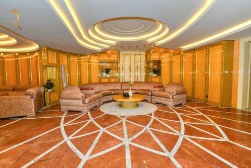 a living room with a couch and a table at Timeless Elegance - Italian-Style Penthouse Retreat Near Corniche & WTC Mall in Abu Dhabi