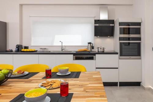 a kitchen with a wooden table with food on it at Avithos - Lassu Retreat in Zóla
