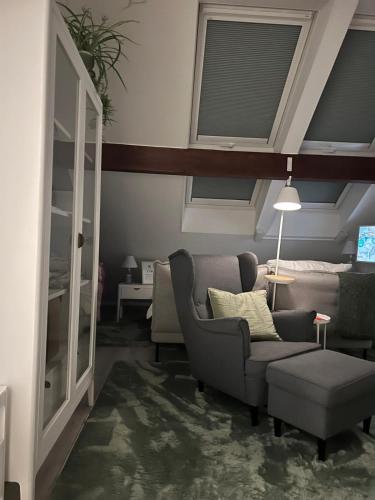 a living room with a couch and a chair at Altstadtnest in Greifswald