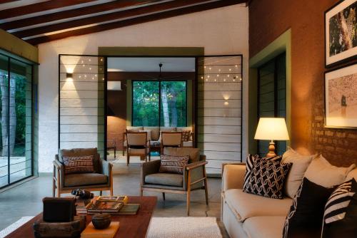 a living room with a couch and chairs at Neem Tree House in Kirinda