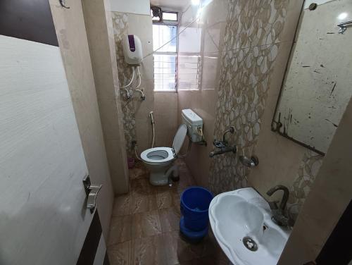 a small bathroom with a sink and a toilet at Hotel Viraat Inn in Gaya