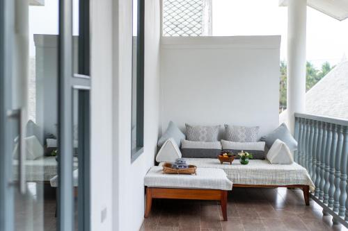 a living room with a couch on a porch at Souphattra Hotel Luang Prabang in Luang Prabang