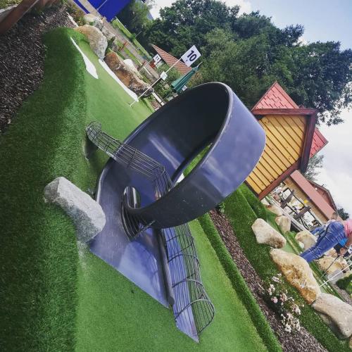 a large blue slide in the grass with a building at Gasthof Meindl in Arrach