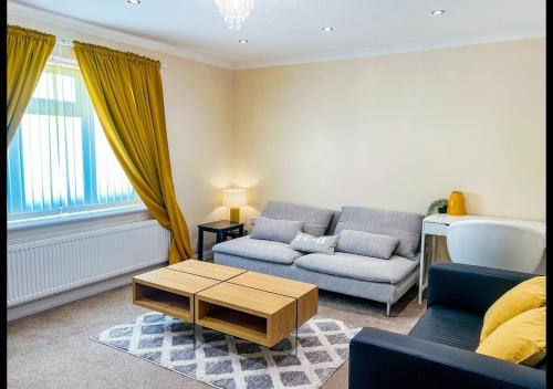 a living room with a couch and a coffee table at Cambridge Apartment at St Neot in Eaton Socon