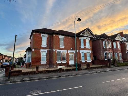 a large brick house on a city street at The Lodge Southampton in Southampton
