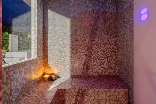 a bathroom with a shower with a large window at Villa Laura in Atri