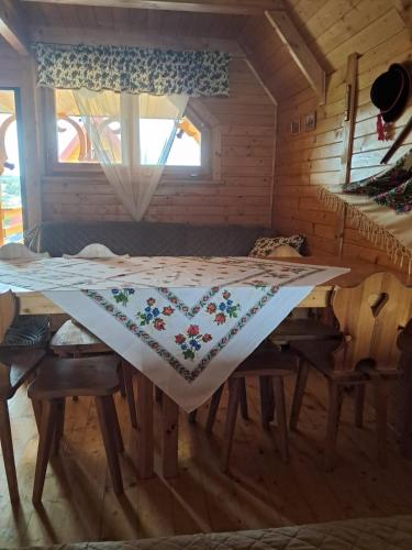 a bed with a quilt on it in a room at Noclegi Korbielów in Korbielów
