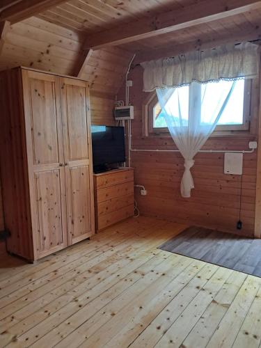 a large living room with a window and a television at Noclegi Korbielów in Korbielów
