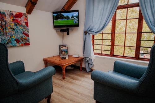 Телевизор и/или развлекательный центр в Aan de Oever Guesthouse