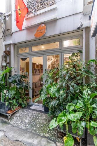 a store front with plants in front of it at AMANGO HOSTEL in Ho Chi Minh City