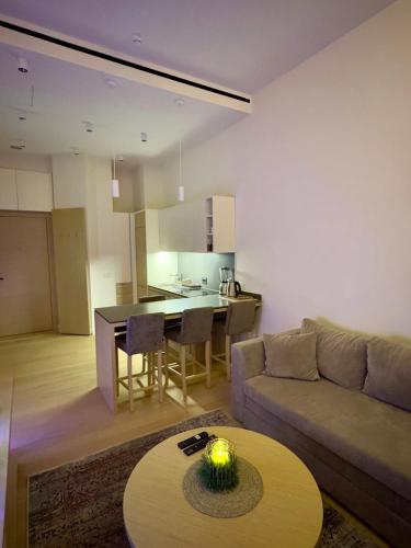 a living room with a couch and a table at Zepterme Apartman 012 in Vrnjačka Banja