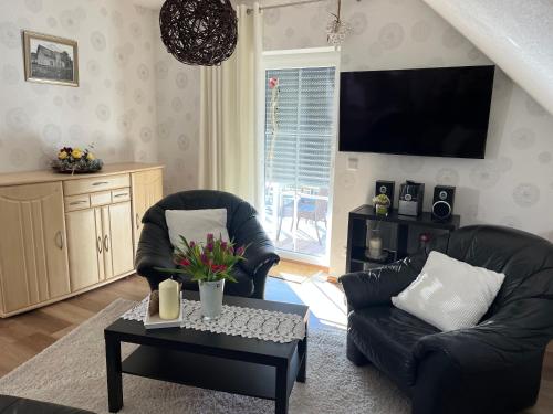 a living room with two chairs and a coffee table at Apartment Luise in Bad Liebenstein
