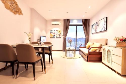 a living room with a table and a couch at Classy Home - CSJ Tower Vũng Tàu, Luxury, Sky-Sea View and Walk-To-Beach in Xã Thang Tam