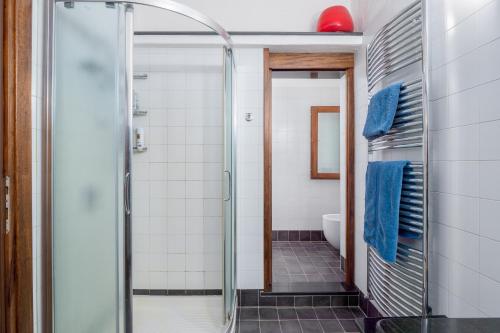 a bathroom with a shower with a glass door at Corbezzoli in San Teodoro