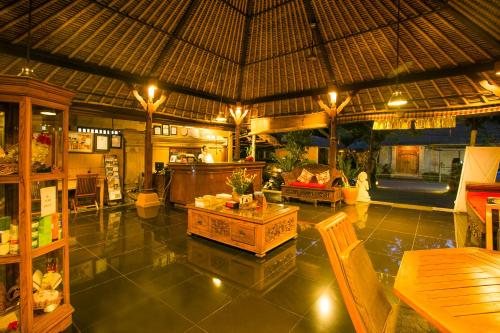 a large room with a restaurant with a table at Saren Indah Hotel in Ubud