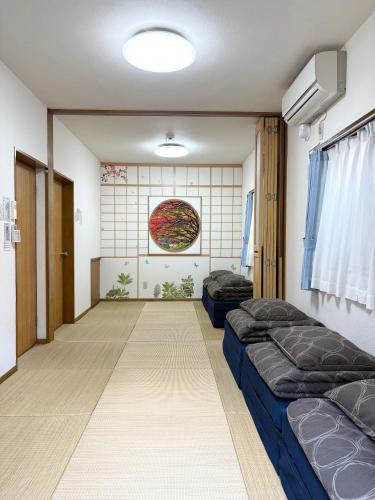 a room with two beds and a wall at Shinjuku12min Shibuya15min Max10ppi Free-Wifi in Tokyo
