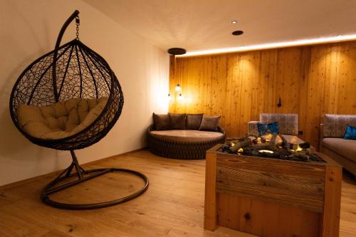 a living room with a swing and a couch at Apartments Hubertushof in Dobbiaco