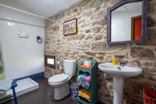 a bathroom with a white toilet and a sink at Chan Da Ra in A Lama