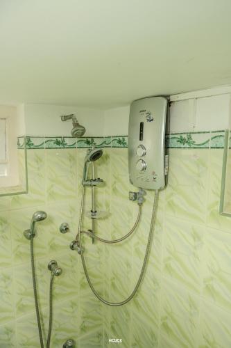 a shower in a bathroom with a shower head at Chamil villa in Galle