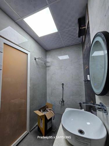 a bathroom with a sink and a mirror and a shower at Hotel Fortune in Ayodhya