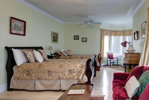 a bedroom with a bed and a table and a couch at Country Encounters Accommodations in Coleman