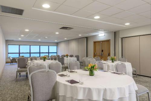 a conference room with white tables and chairs at Hilton Copacabana Rio de Janeiro in Rio de Janeiro