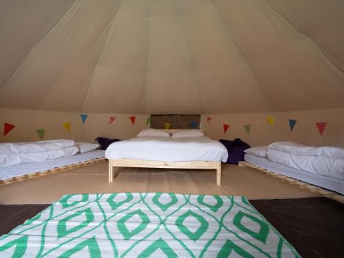 a room with three beds in a tent at YHA Whitby in Whitby
