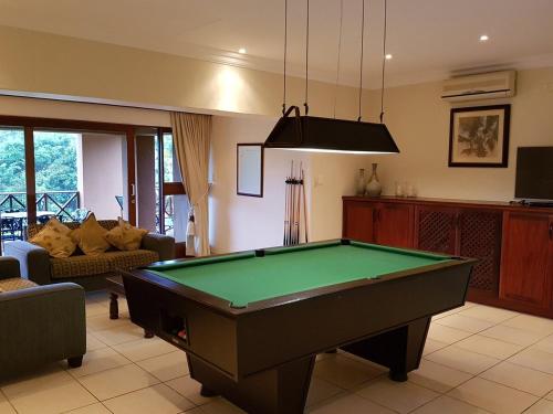 a living room with a pool table in it at Luxury 4 bed villa in San Lameer golf beach estate in Southbroom