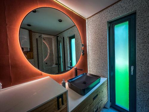 a bathroom with a sink and a large mirror at "Rózin Pstrągarnia" domki całoroczne Jura Krakowsko-Częstochowska in Krzeszowice