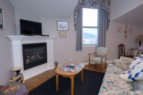 a living room with a couch and a fireplace at Country Encounters Accommodations in Coleman