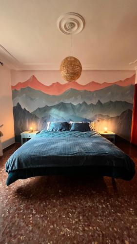 a bedroom with a bed with a mountain mural on the wall at Dulcevida in Riópar