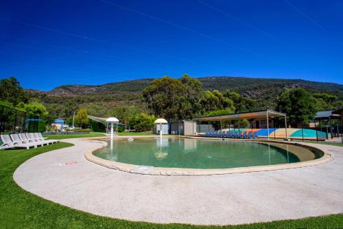 a pool with a pool table and chairs in it at BIG4 NRMA Halls Gap Holiday Park in Halls Gap