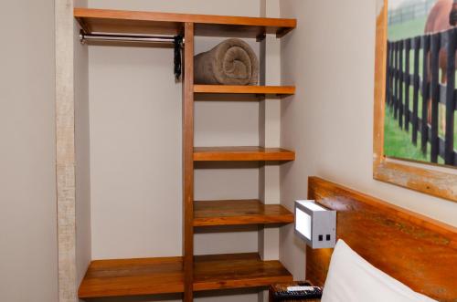a room with a wooden book shelf on a wall at Meu Hotel Boituva in Boituva