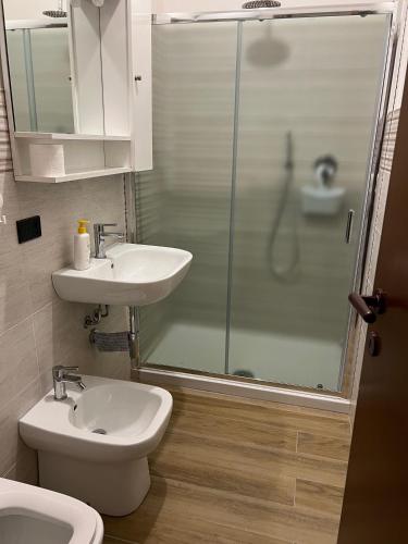 a bathroom with a shower and a sink and a toilet at Monolocale La torre in Rio Marina