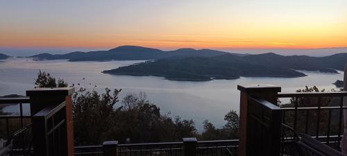 a view of a body of water at sunset at Agnanti Limnis Hotel in Neochori
