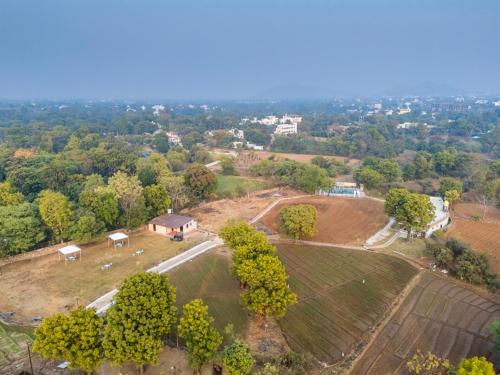 an aerial view of a farm with trees and a house at Indulge Udaipur by Pack in Udaipur