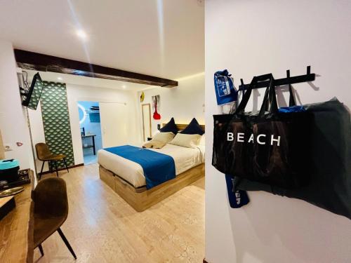 a bedroom with a bed and a bag on the wall at Emilysuites - Malaga Centro Historico in Málaga