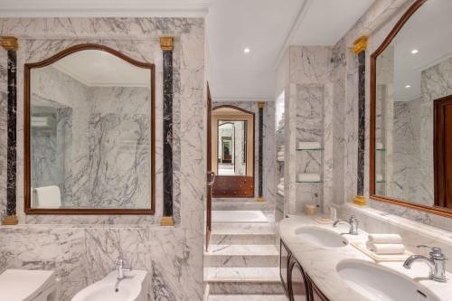 a bathroom with two sinks and two mirrors at ITC Windsor, a Luxury Collection Hotel, Bengaluru in Bengaluru