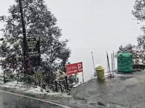 a sign on the side of a road in the snow at Sleeping Beauty Hotel Moutain view property in Joshīmath