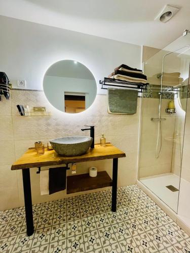 a bathroom with a sink and a mirror and a shower at Emilysuites - Malaga Centro Historico in Málaga