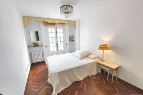 a bedroom with a bed and a table with a lamp at Spacious house with terrace and balcony in A Coruña in A Coruña
