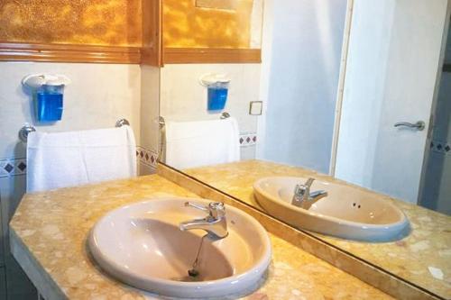 a bathroom counter with two sinks and a mirror at Comfortable house near Esparreguera with city view in Esparreguera