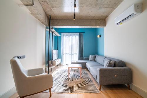 a living room with a couch and two chairs at RudBlu Suites in Antalya