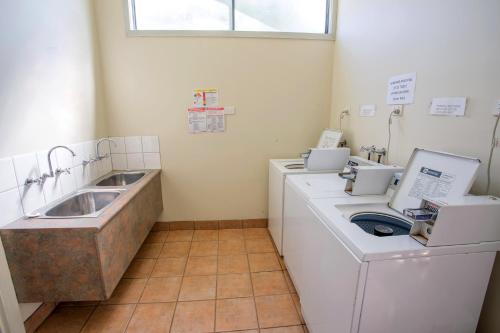 a bathroom with two washing machines and a sink at NRMA Halls Gap Holiday Park in Halls Gap
