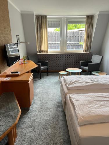 a hotel room with a bed and a desk at Hotel Lachnerhof in Erlangen