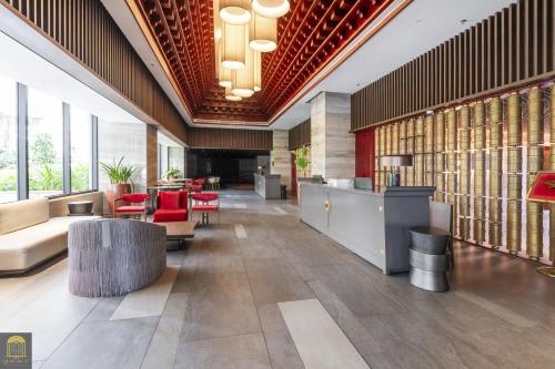 a lobby of a building with tables and chairs at Mandala Pearl Azure Retreat in Ấp Nhơn Long