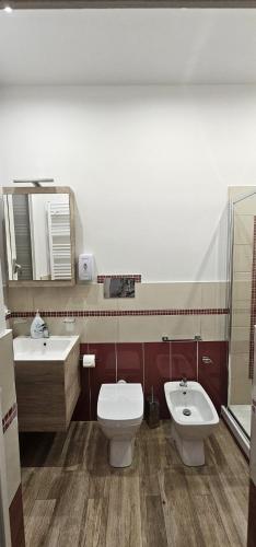 a bathroom with a toilet and a sink at B&b A Due Passi Dal Sole in Porto Empedocle